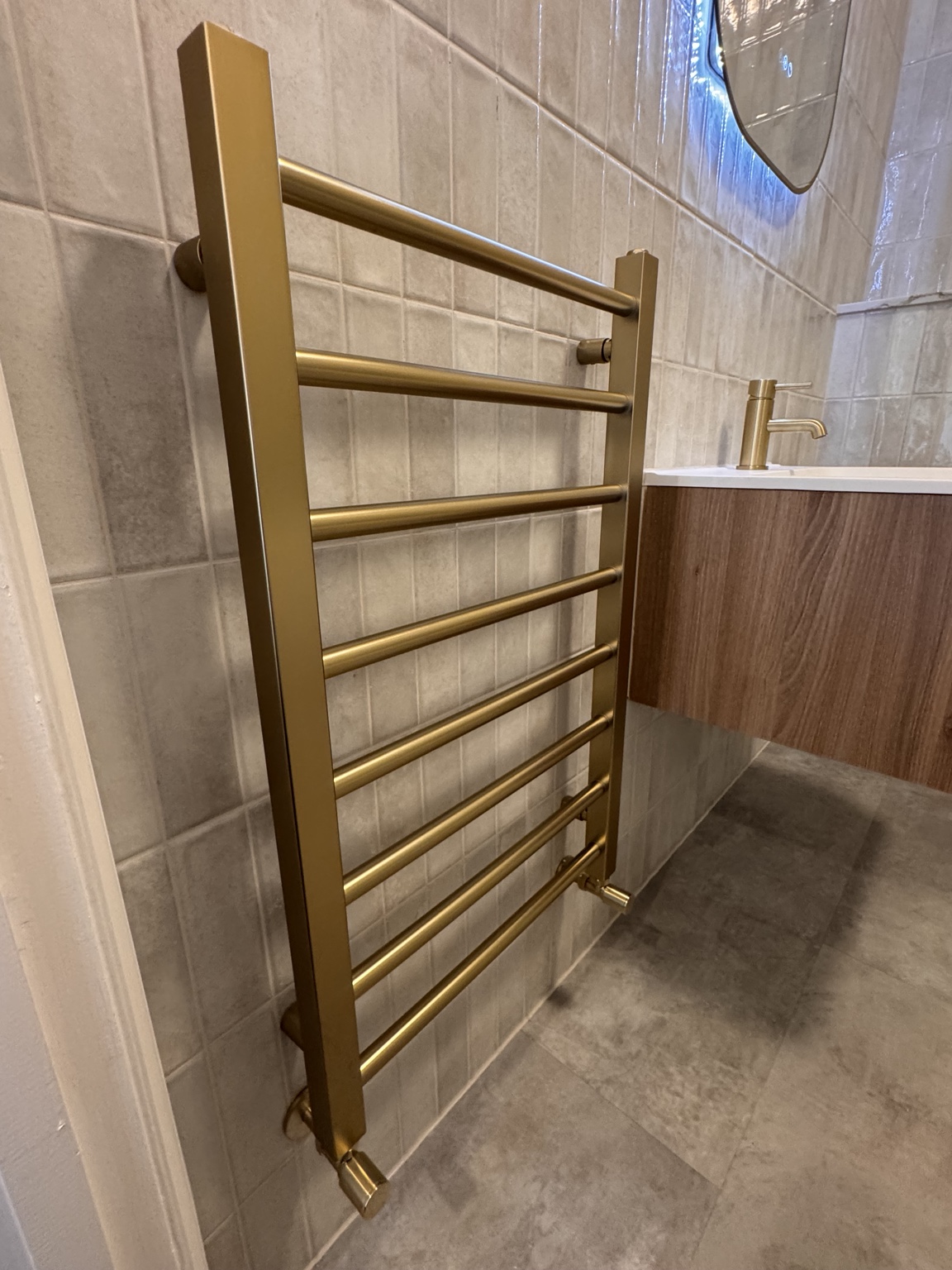 Brass-finish ladder towel rail installed by SMC